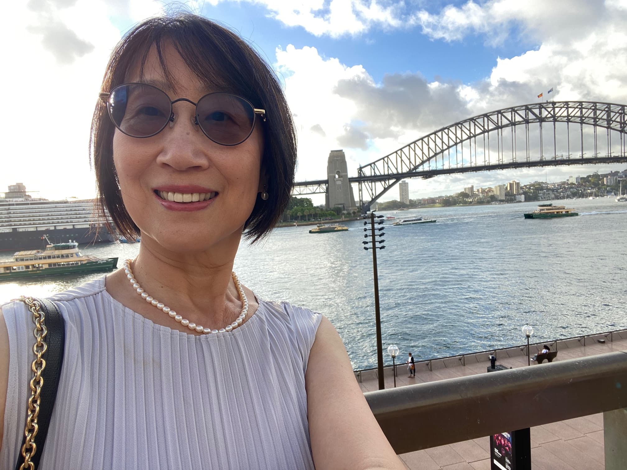 Yan smiling with the Sydney Harbour Bridge in the background